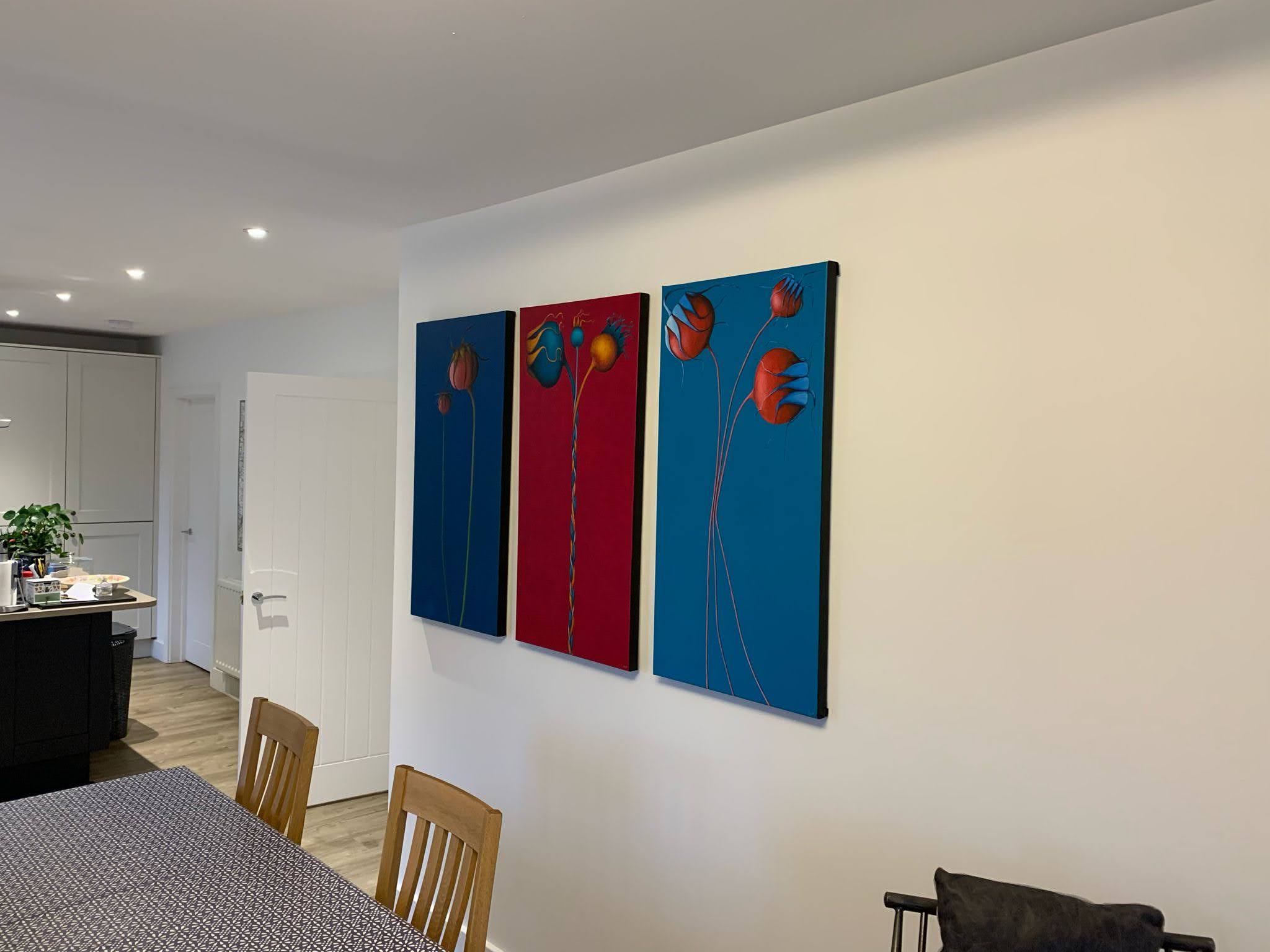 Colorful abstract wall art on a white wall in a modern living room. Louisa Corr original art uk gallery triptych
