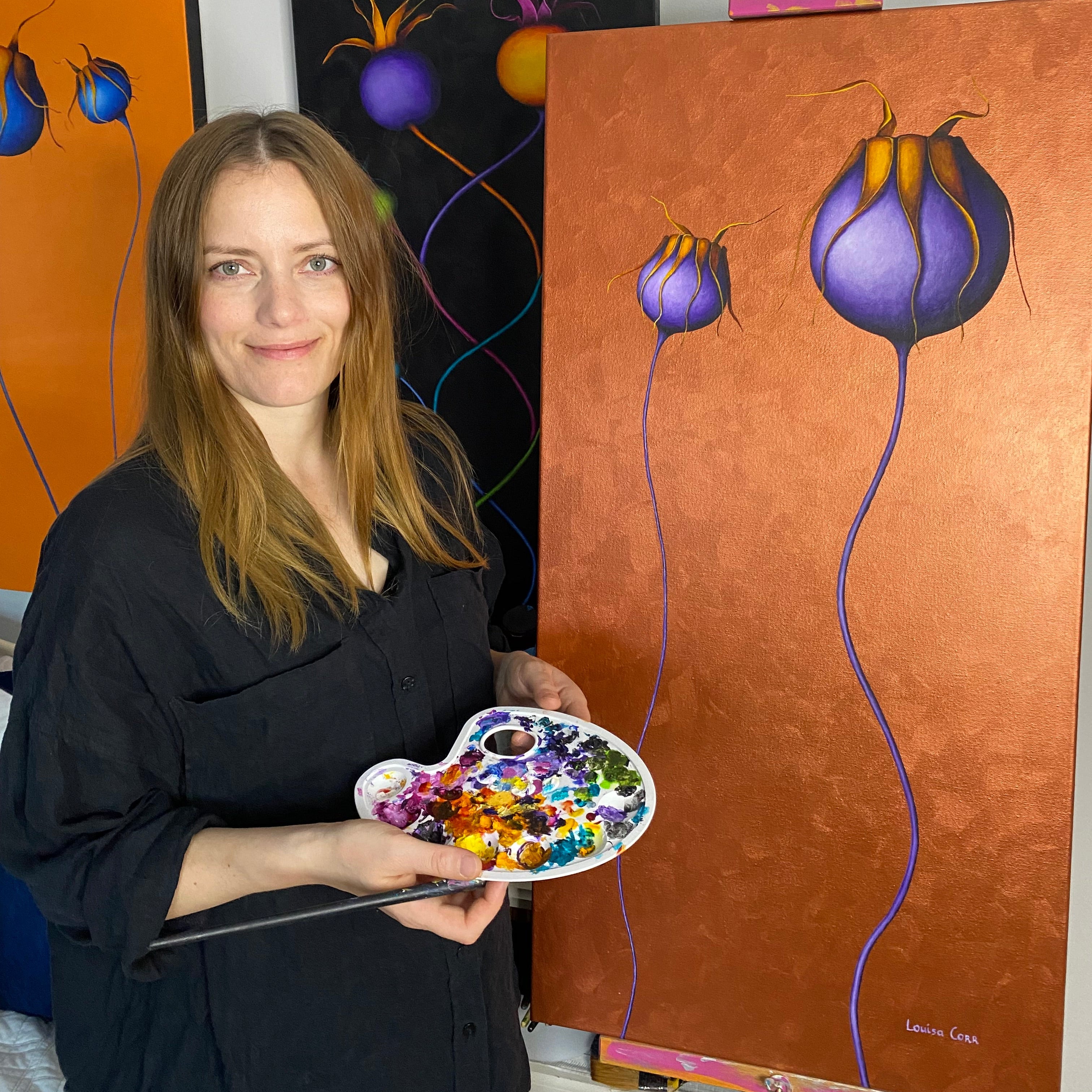 Louisa Corr Botanical Contemporary Fine Artist holding a paint palette with a colorful flower painting in the background