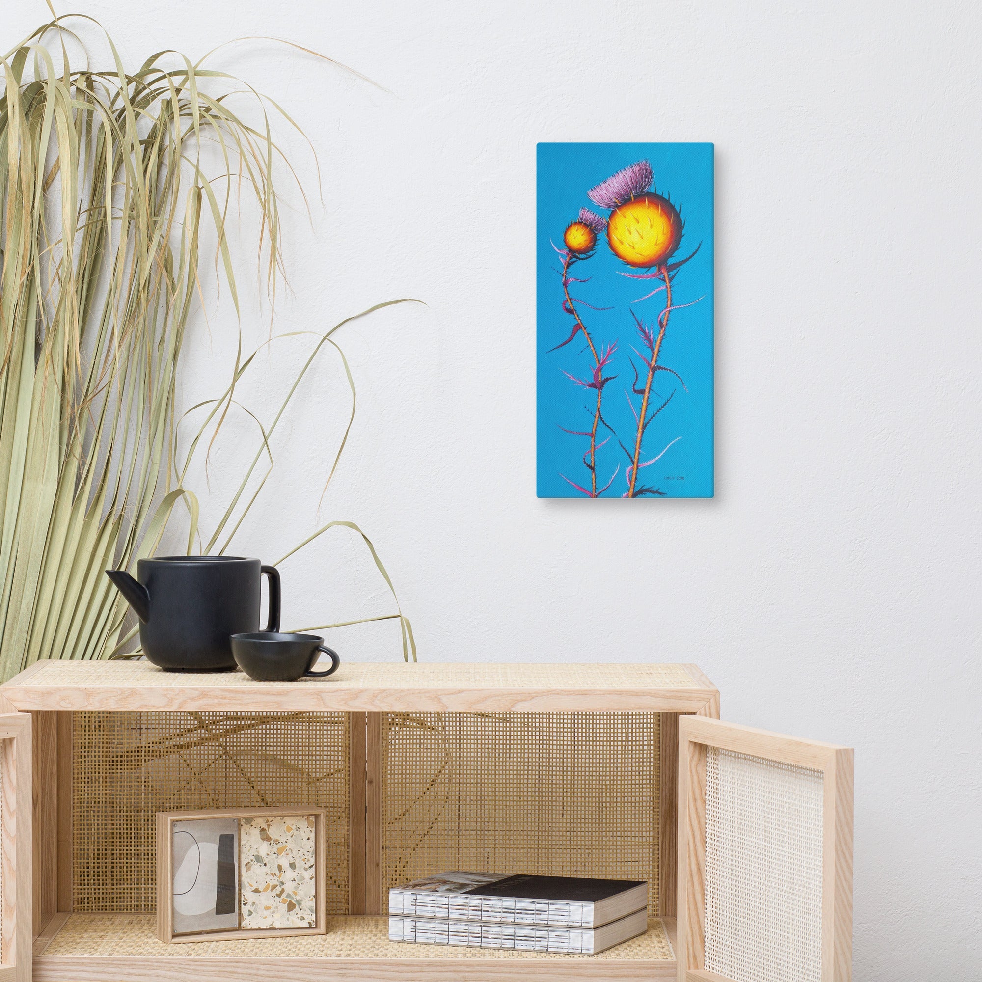 Decorative shelf with a teapot, cup, and framed artwork on a white wall. Contemporary poppy botanical print, bold summer floral artwork