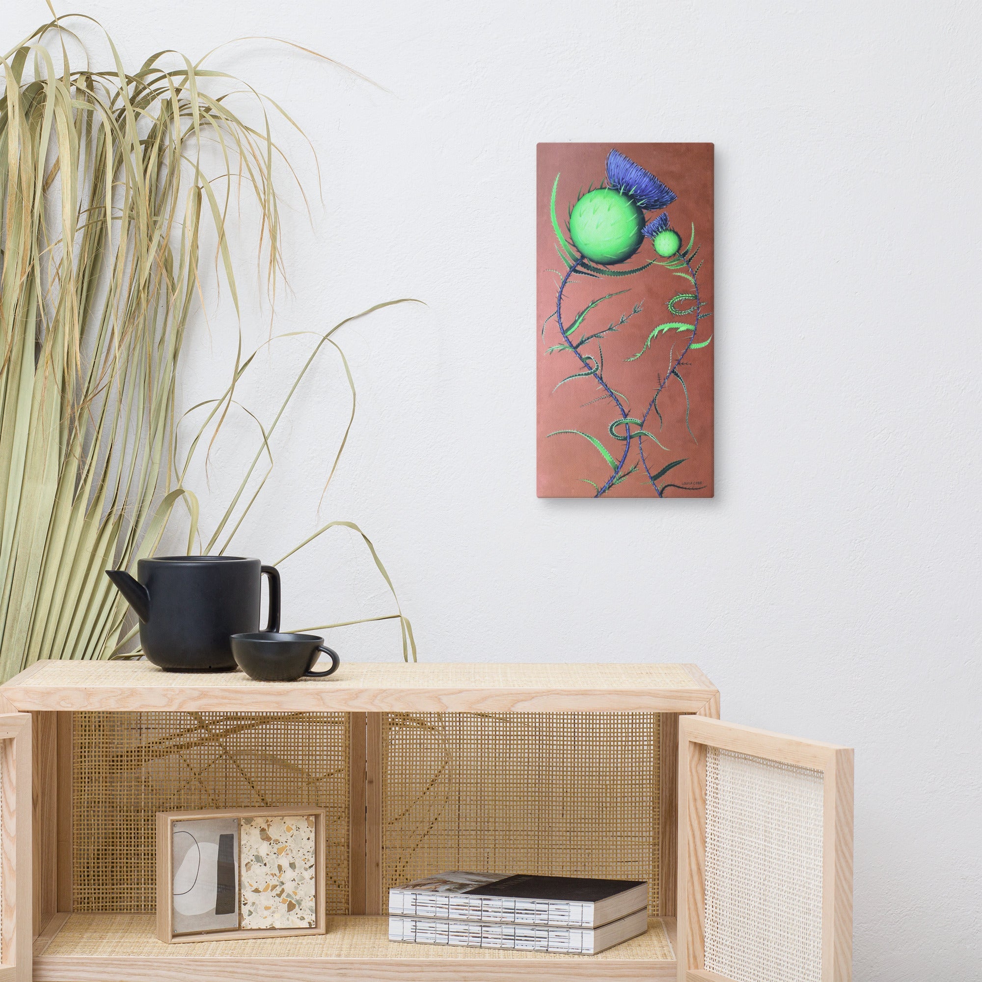 Fine art and decorative items against a white wall with a colorful abstract painting.