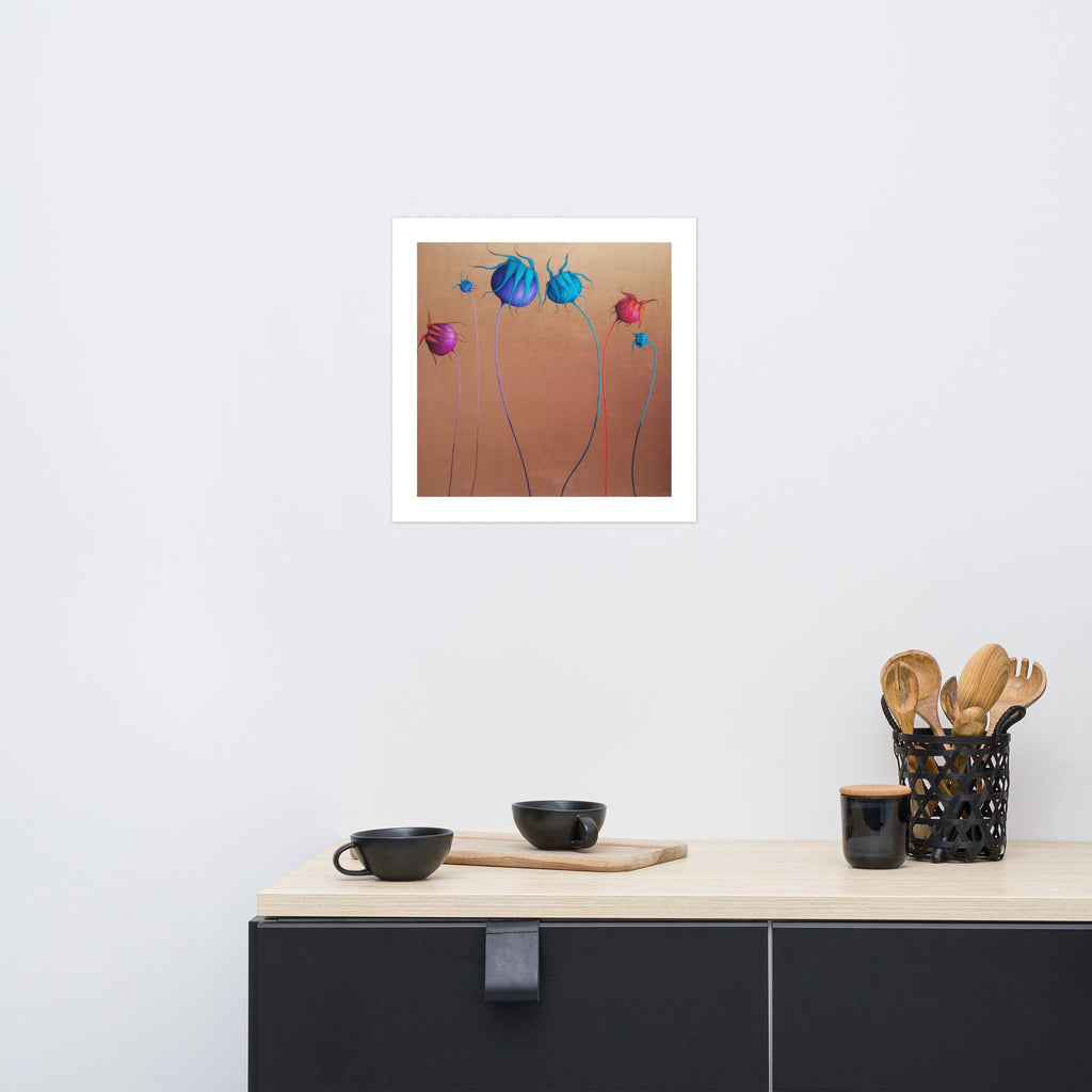 Art print of colorful flowers on a wall above a kitchen counter with black cabinets.
